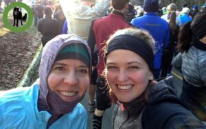 Baylee and her mom from the shoulders up with heads together at finish of MEC run.