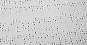 A sheet of plain white Braille rests flat.