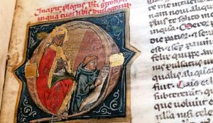 A 14th century letter Q with an image of gregory the great and a scribe working inside it.